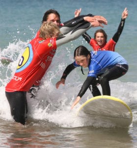 Girl Surfing in Surf Lesson