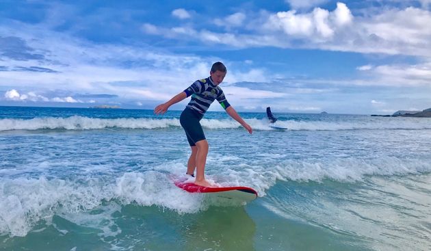 boy learning to surf in Cornwall