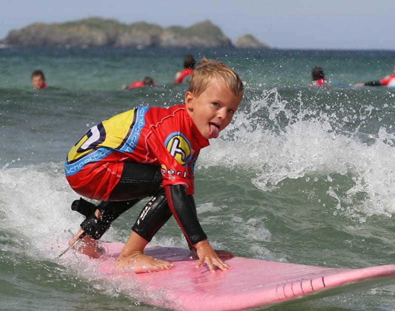 Surf School kid riding a wave